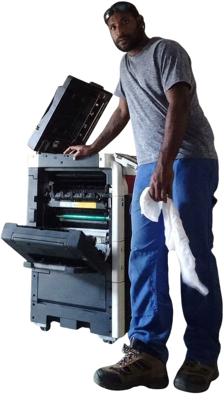 Pulse and Bytes technician standing beside an office printer